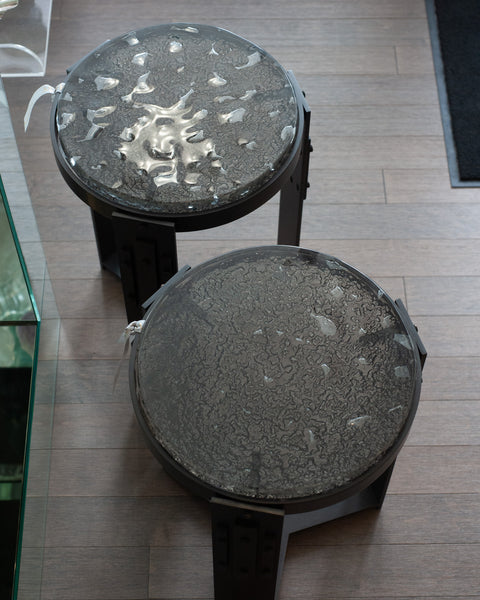 STUDIO MAISON NURITA PAIR OF SMOKED GLASS TABLES WITH BLACKENED BRASS BASES