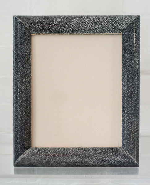 A large picture frame in blue/black Shagreen & walnut, backed in suede.