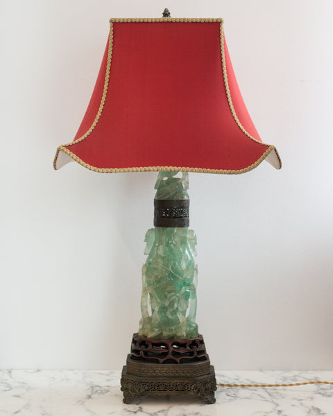 A beautiful large Antique Chinese carved fluorite lamp on a bronze base with a custom "Pagoda" shade in red silk and vintage metallic trim, re-wired with a silk cord. When switched on, the carved fluorite is illuminated from the inside.